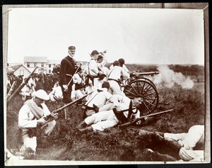 Copyphotograph of an earlier photo of soldiers from the New York Naval Reserves involved in a mock battle with guns and cannon, Fishers Island, New York, 1917